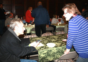 Cameryn Flynn, Business Development Services coordinator with SNAP Financial Stability (right) talks to a resident of East Sprague about the agency’s micro-enterprise program. 