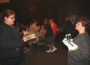 Kim Kreber, SNAP Conservation Education coordinator, discusses energy saving themes with a resident of East Sprague on Feb. 1.